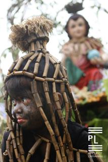 A niño covered in soot emulating the Sto. Niño. - 